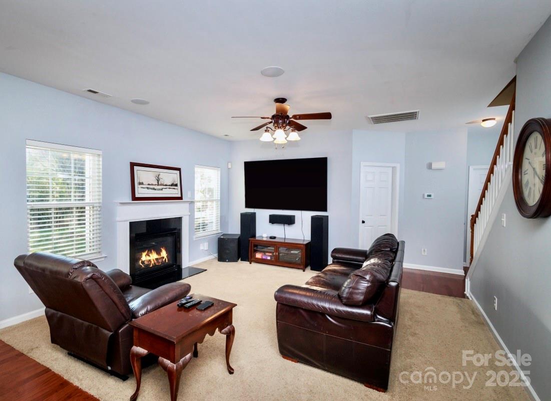 1457 Prestbury Road Northwest Concord, NC 28027 - Photo 11 of 19 a living room with furniture a fireplace and a flat screen tv