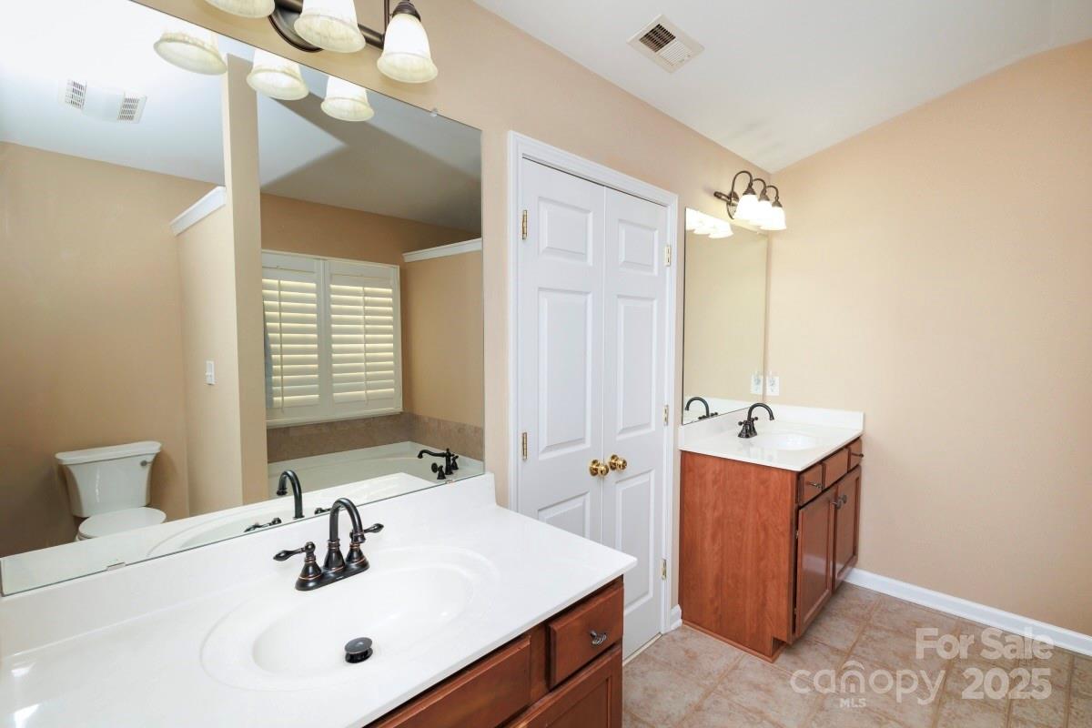 1457 Prestbury Road Northwest Concord, NC 28027 - Photo 10 of 19 a bathroom with a tub sink and mirror