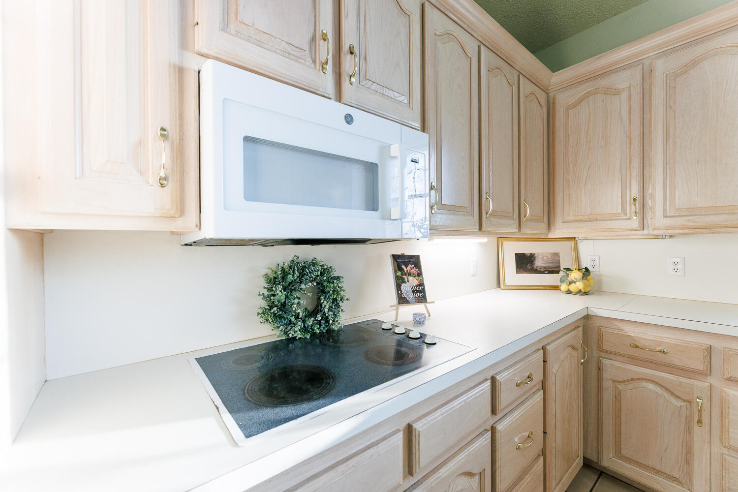 206 Collins Avenue Sundown, TX 79372 - Photo 19 of 82 a kitchen with white cabinets and white appliances