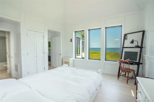 a bedroom with a large bed and a large window