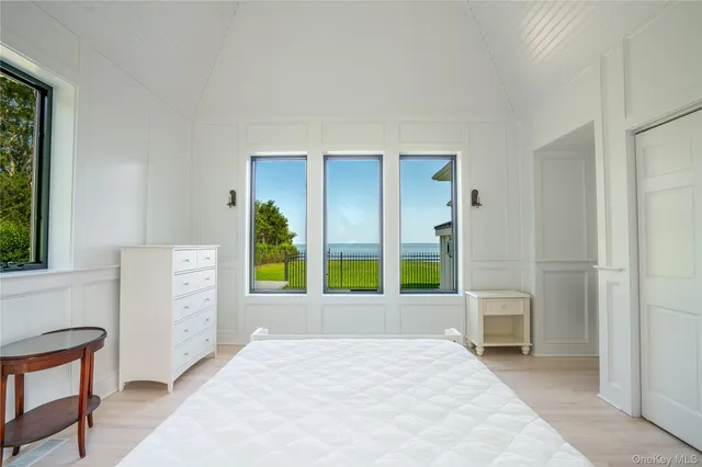 a bedroom with a bed a table and a window