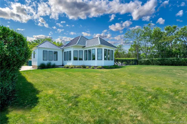 a view of a house with a yard and sitting area