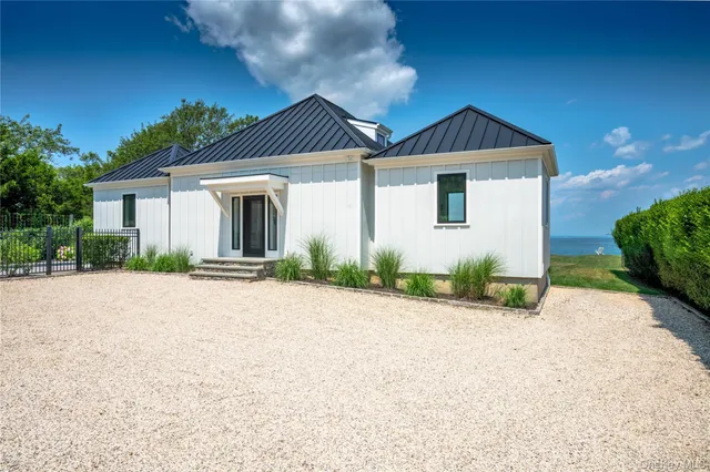 a view of a house with a big yard and garden