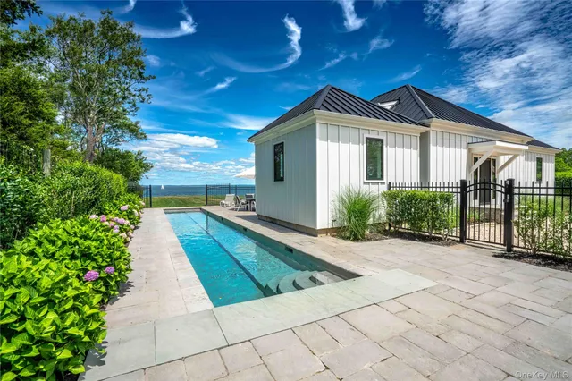 a view of a house with a small yard plants and large tree