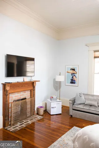 a bedroom with a bed a couch and bookshelf