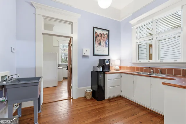 a living room with furniture a flat screen tv and a large window