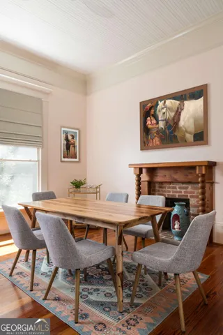 a bed room with a bed a television and a window