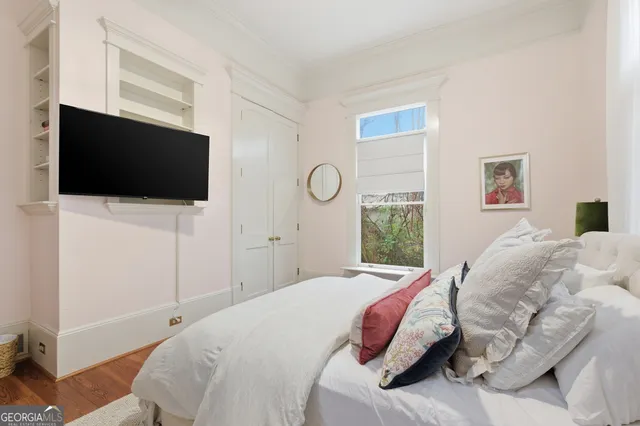 a bedroom with a bed and a large window