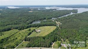 an aerial view of residential houses with outdoor space and trees
