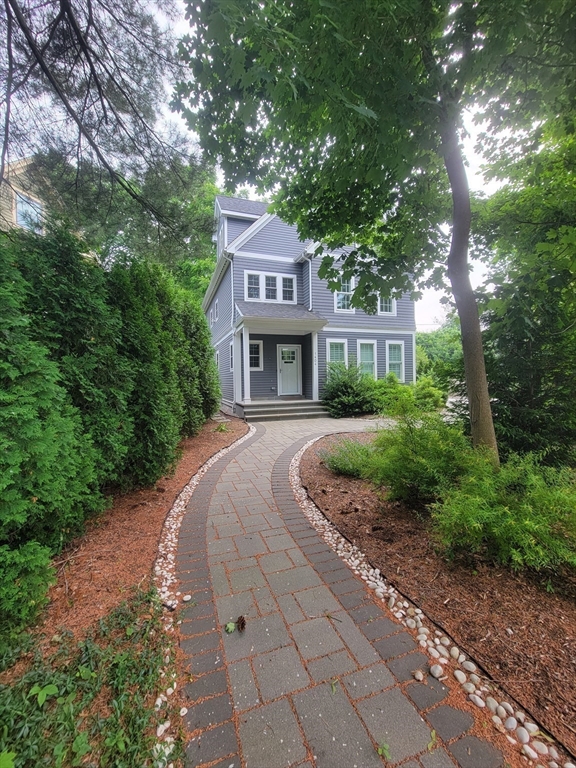 1404 Centre Street Newton, MA 02459 - Photo 1 of 1 a front view of a house with garden and trees