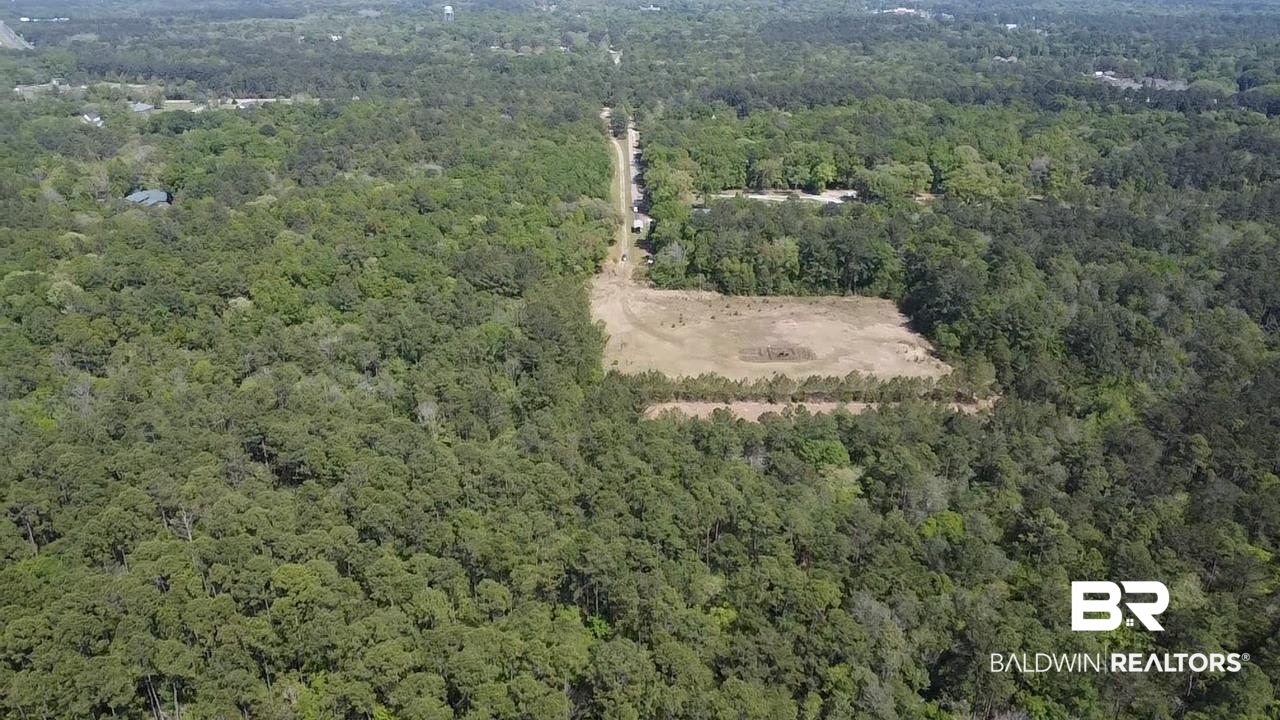 0 I-65 Service Road Satsuma, AL 36572 - Photo 15 of 27 Drone / aerial view featuring a wooded view