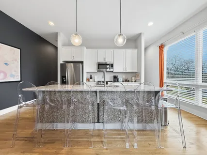 a kitchen with stainless steel appliances granite countertop a sink and a stove
