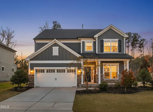 a front view of a house with a yard and garage
