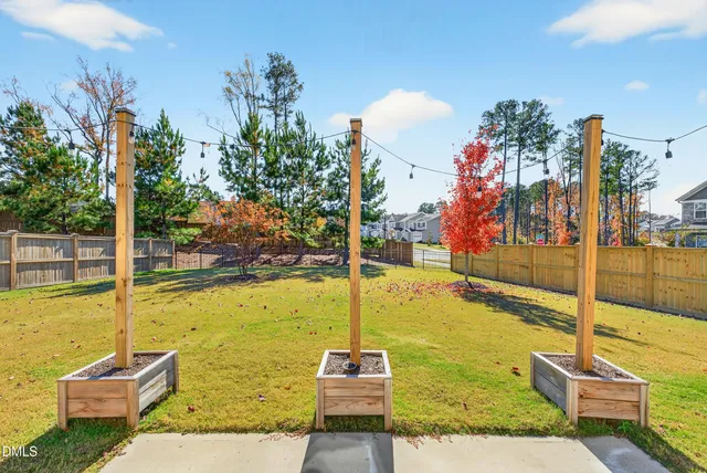 a view of a swimming pool with a lawn chairs under an umbrella