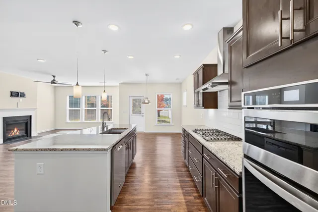 a kitchen with stainless steel appliances granite countertop a stove and a sink