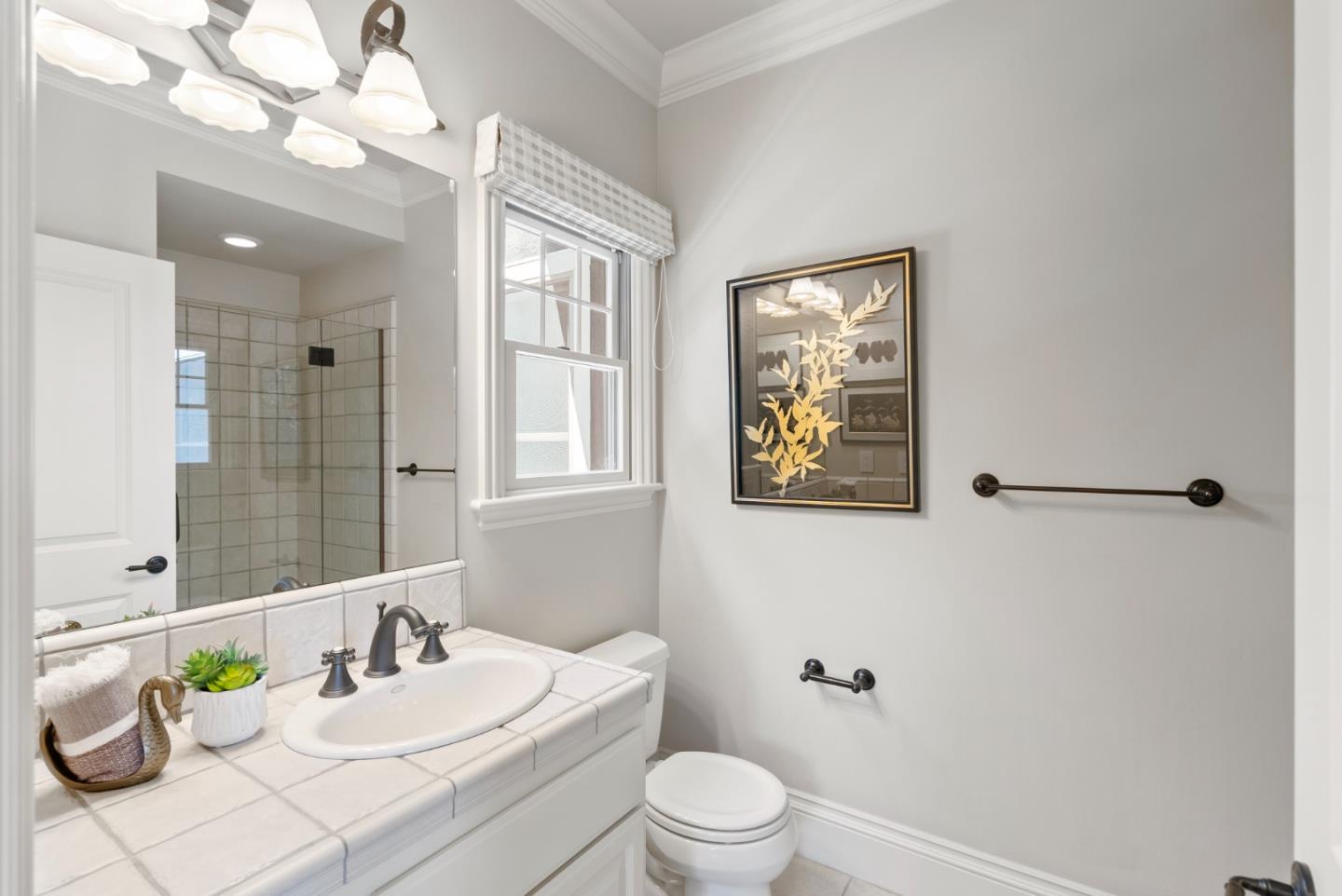 125 Dover Street Los Gatos, CA 95032 - Photo 26 of 49 a bathroom with a sink vanity mirror and toilet