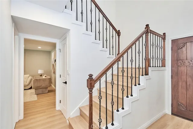 a view of staircase with wooden floor and a bathroom