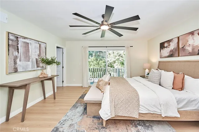 a bedroom with a large bed and a chandelier