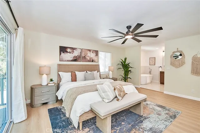 a bedroom with a bed furniture and a large window