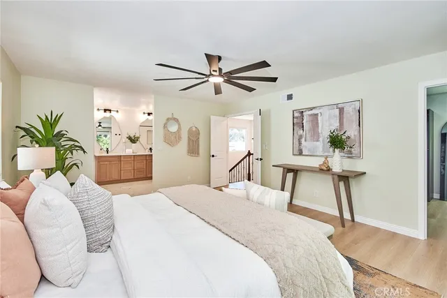 a bedroom with a bed and a chandelier