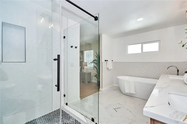 a bathroom with a bathtub and a shower