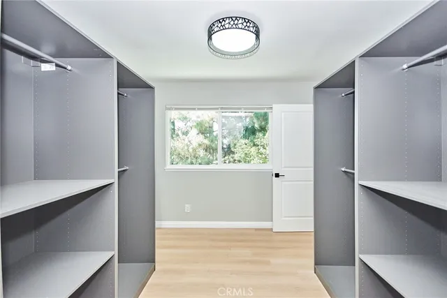 a view of a room with wooden floor and window
