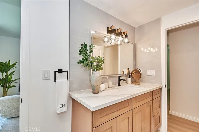 a bathroom with a sink a vanity and a mirror