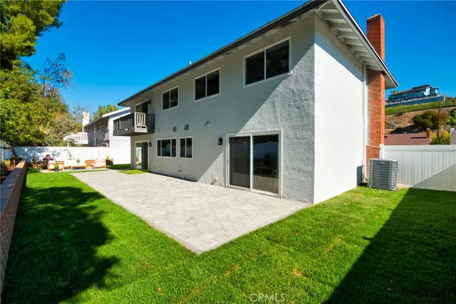 a view of house with backyard