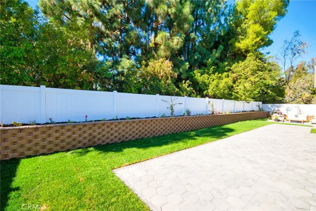 a view of green field with wooden fence