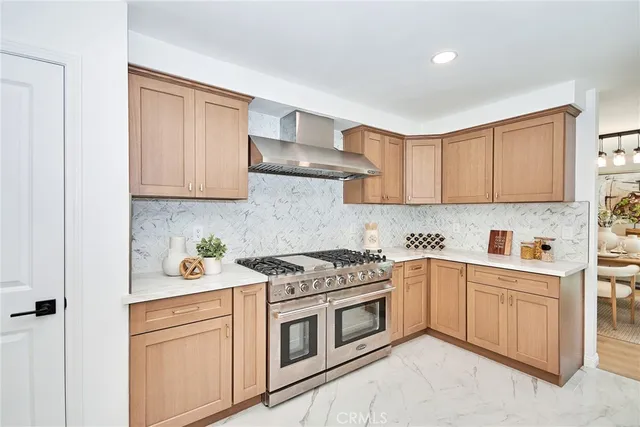 a kitchen with stainless steel appliances granite countertop a sink and cabinets