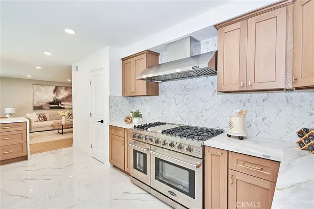 a kitchen with stainless steel appliances granite countertop a stove and a sink