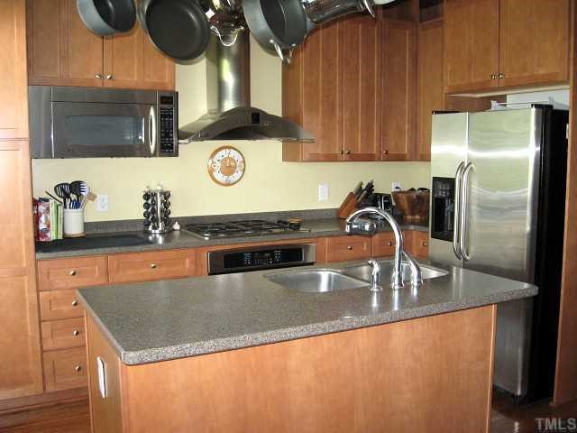 Gourmet kitchen with gas cooktop, island, & stainless steel appliances