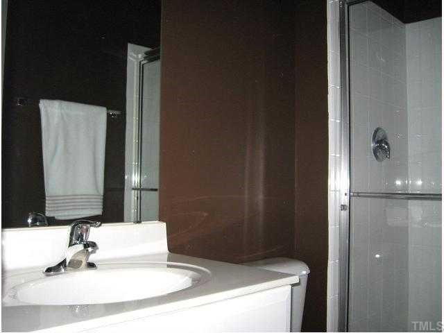 1230 Capability Drive, Unit 102 Raleigh, NC 27606 - Photo 9 of 12 Second full bath with large shower & tile floor