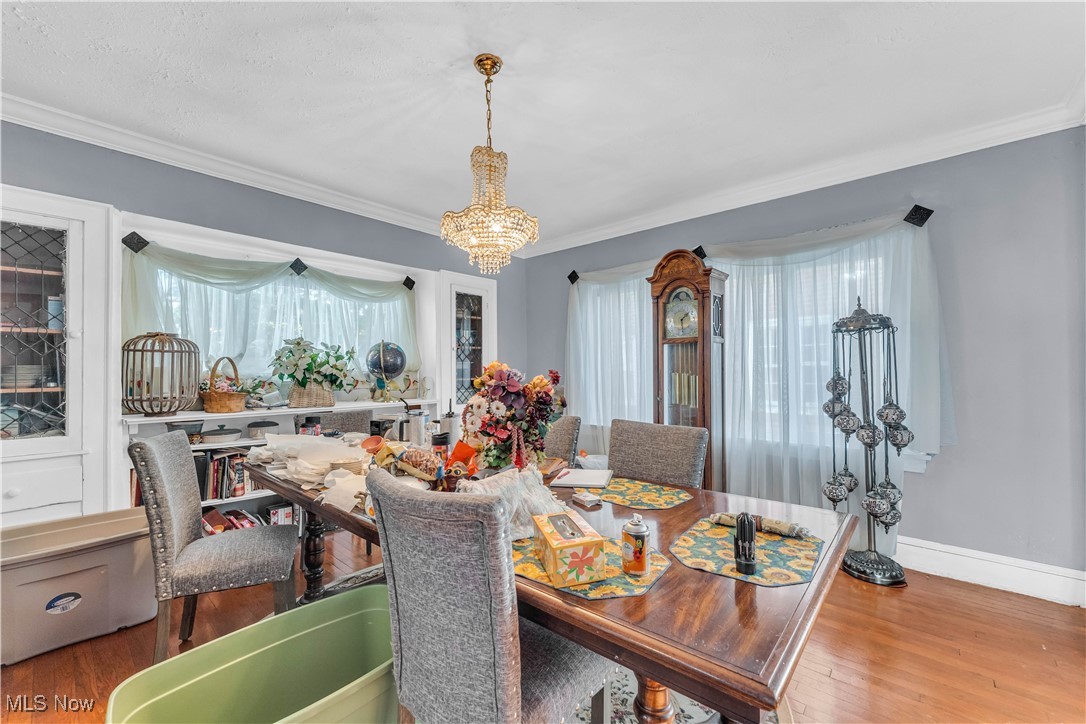 2123 North Taylor Road Cleveland Heights, OH 44112 - Photo 12 of 38 Dining area featuring a chandelier, hardwood / wood-style floors, and ornamental molding