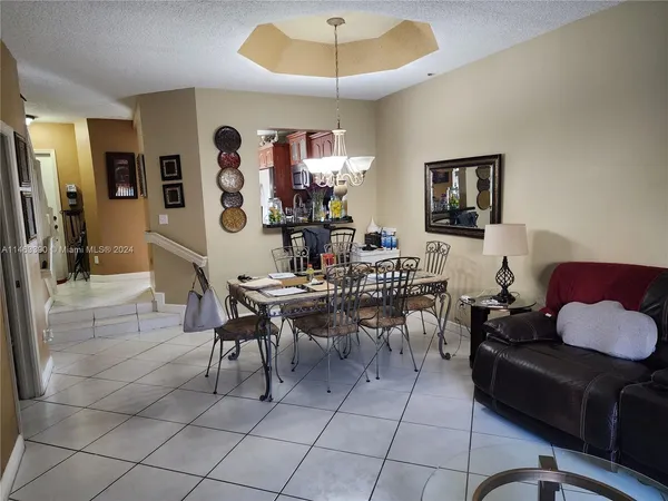 a dining room with furniture and a chandelier