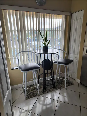 a view of a room with furniture and a window