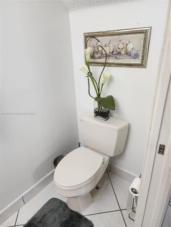 a white toilet sitting next to a bathroom sink