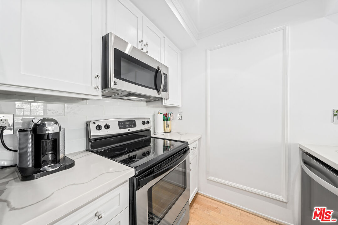 750 North Kings Road, Unit 204 Los Angeles, CA 90069 - Photo 13 of 23 a kitchen with a stove and a microwave
