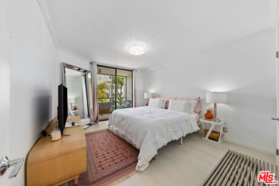 750 North Kings Road, Unit 204 Los Angeles, CA 90069 - Photo 15 of 23 a bedroom with a bed window and a flat screen tv