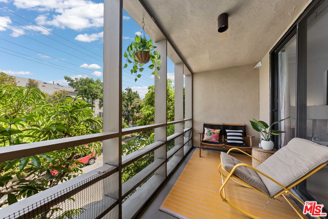 750 North Kings Road, Unit 204 Los Angeles, CA 90069 - Photo 20 of 23 a view of a chairs and table in a balcony