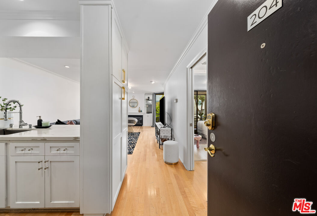 750 North Kings Road, Unit 204 Los Angeles, CA 90069 - Photo 3 of 23 a view of a kitchen from the hallway