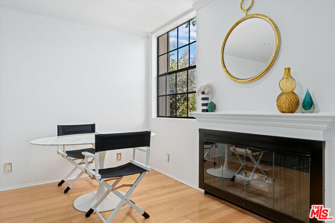 750 North Kings Road, Unit 204 Los Angeles, CA 90069 - Photo 7 of 23 a living room with a table and a fireplace