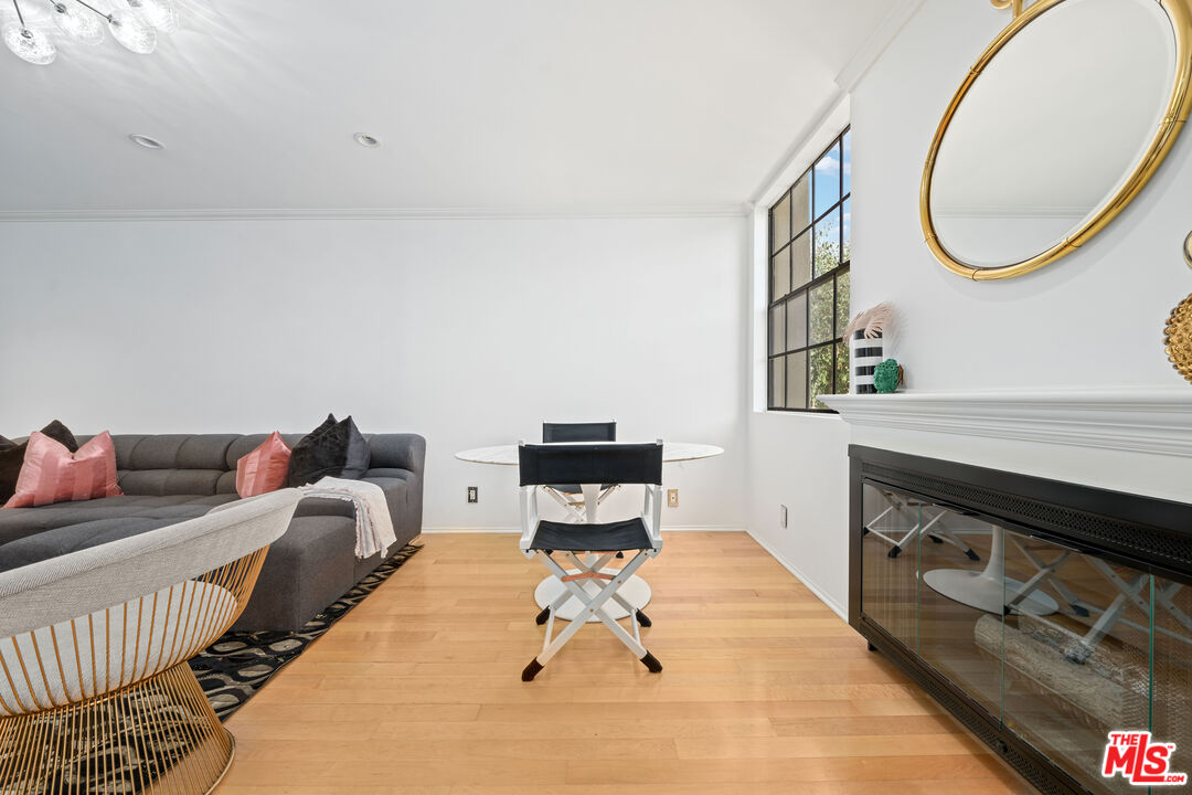 750 North Kings Road, Unit 204 Los Angeles, CA 90069 - Photo 9 of 23 a living room with furniture and a fireplace
