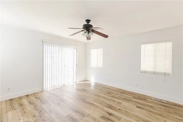 wooden floor in an empty room with a window
