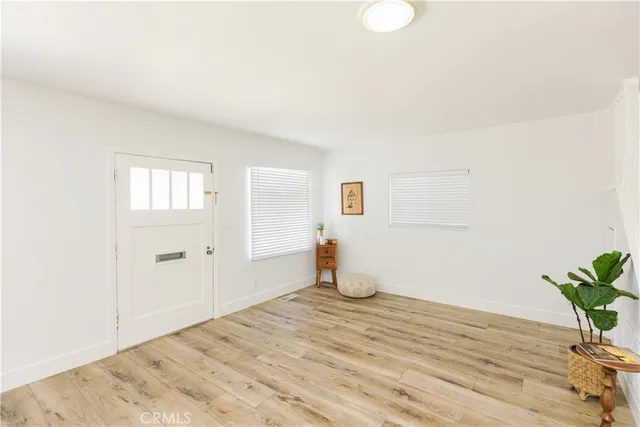 a room that has a bed and a potted plant