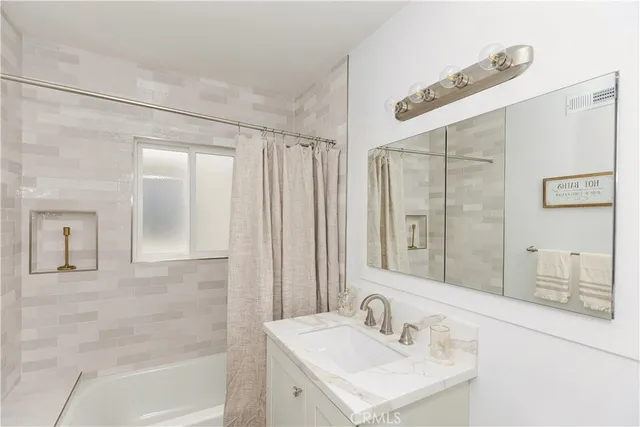 a bathroom with a sink a mirror and a shower