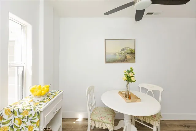 a dining room with furniture and wooden floor