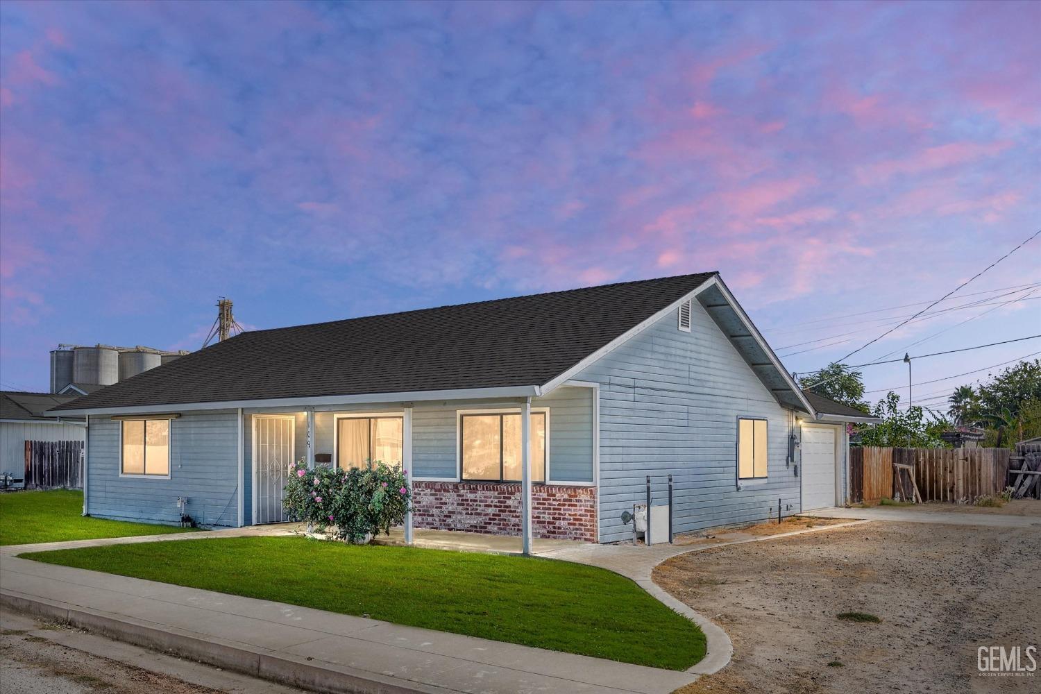 Undisclosed Address Chowchilla, CA 93610 - Photo 1 of 29 a front view of a house with a yard and garage