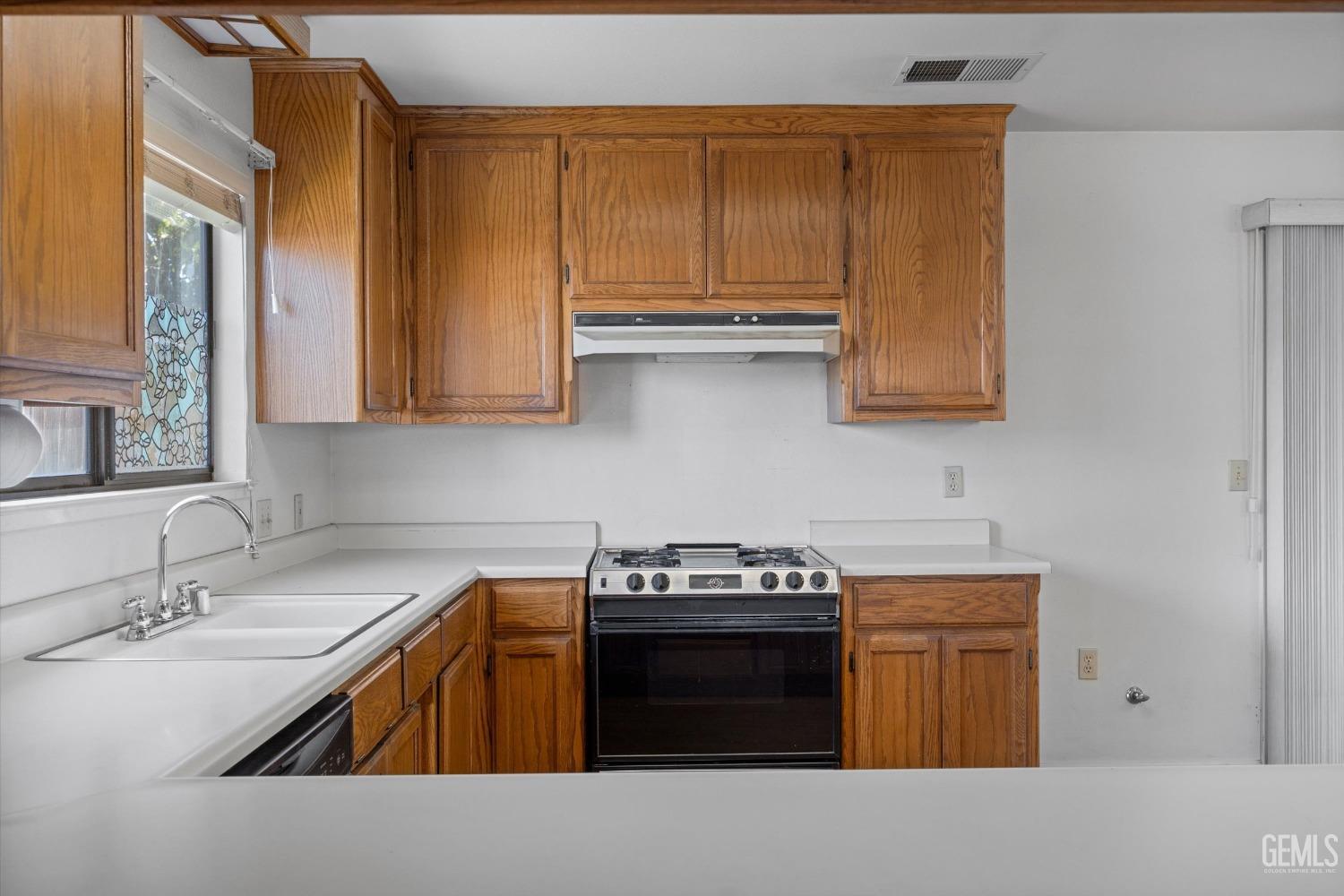 Undisclosed Address Chowchilla, CA 93610 - Photo 11 of 29 a kitchen with stainless steel appliances granite countertop a sink stove and cabinets