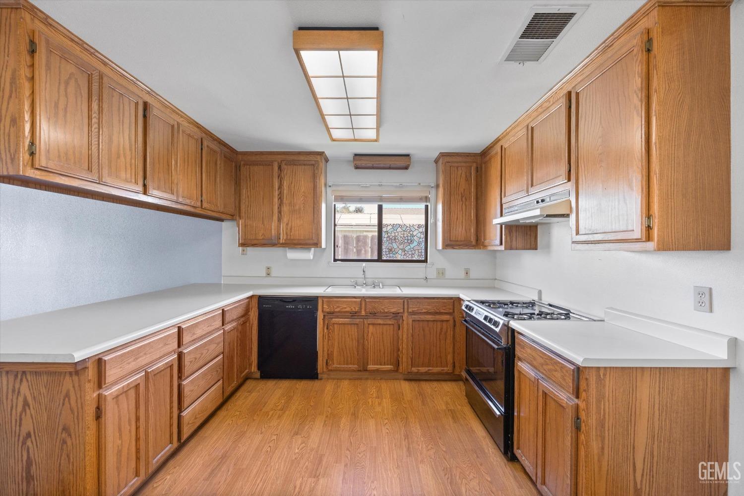 Undisclosed Address Chowchilla, CA 93610 - Photo 12 of 29 a kitchen with stainless steel appliances granite countertop wooden cabinets a sink and a stove